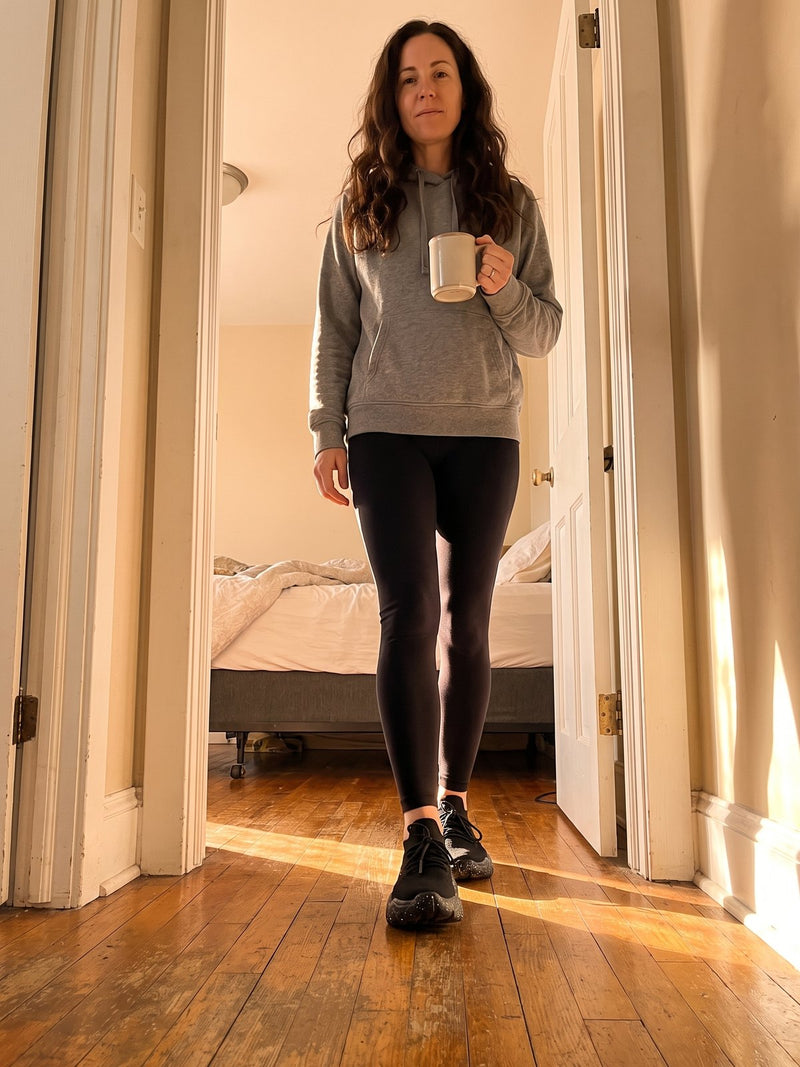 A woman starting her morning at home wearing Again Walk